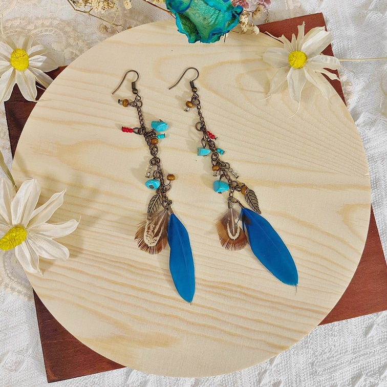 lush elemental blue feather earrings