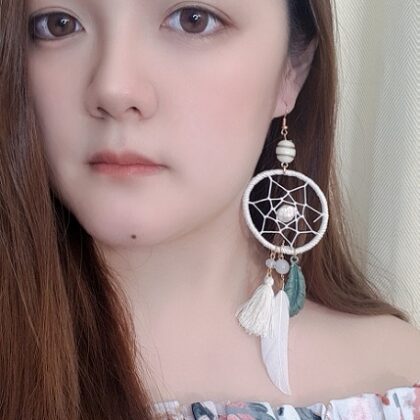 model wearing ivory dreamcatcher earrings