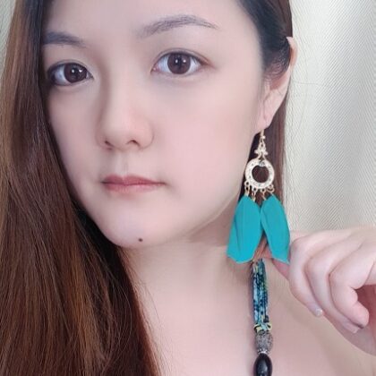 model wearing ophelia aqua boho feather earrings